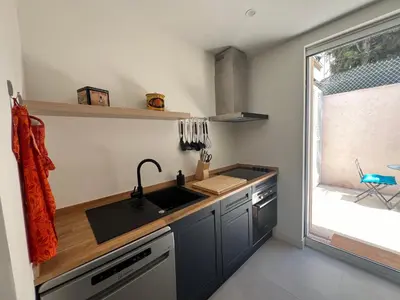 a small kitchen with a sink and a window at Splendide maison Solstice in Cannes
