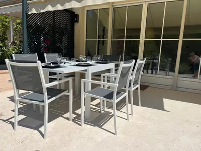 a white table with chairs and wine glasses on it at Splendide maison Solstice in Cannes