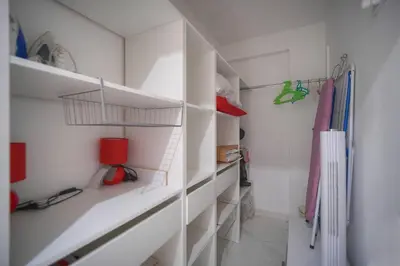 a white walk in closet with white walls and shelves at FRGK Victoria 4 Central Cannes 1BR Terrace, AC & Ultra-Fast Wi-Fi in Cannes