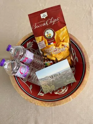 a plate with snacks and a bottle on a table at Appartement Vue Mer avec Piscine - Cannes in Cannes