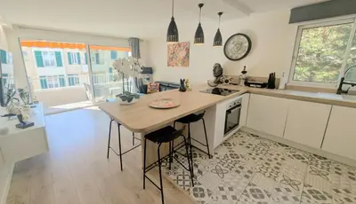 a kitchen with a table and a counter with a clock at 