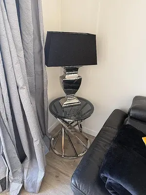 a lamp sitting on a table next to a couch at 