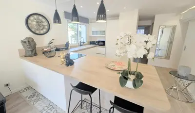 a kitchen with a counter with a vase of flowers at 