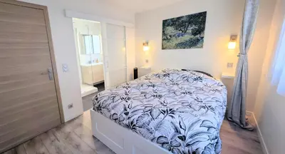 a bedroom with a bed and a bathroom with a door at 