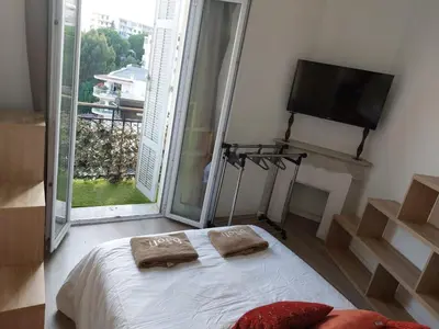 a bedroom with a bed and a flat screen tv at Stanislas sea view in Cannes