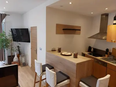 a kitchen with a island in the middle of a room at Stanislas sea view in Cannes