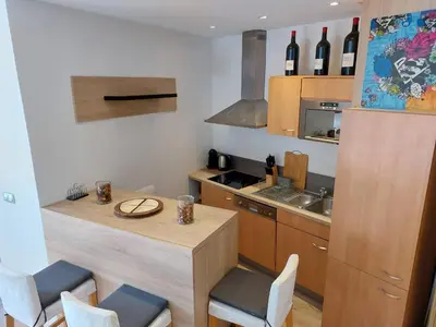 a kitchen with a table and chairs and a counter top at Stanislas sea view in Cannes
