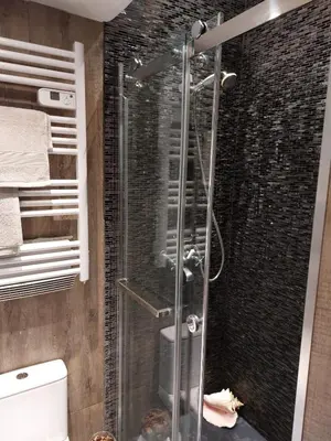 a shower with a glass door in a bathroom at Stanislas sea view in Cannes