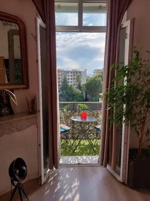 an open door to a balcony with a table at Stanislas sea view in Cannes