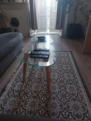 a glass coffee table with a keyboard on top of a rug at Stanislas sea view in Cannes