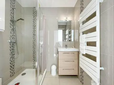 a white bathroom with a shower and a sink at Le ROUAZE studio - proche Carlton et Martinez - idéal congrès - Wifi Clim in Cannes
