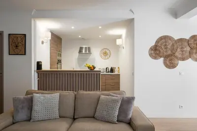 a living room with a couch and a kitchen at Cannes Center, Nice 110m2, 3BR & 3BTH, Terrace in Cannes