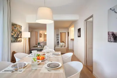 a dining room with a table and white chairs at Cannes Center, Nice 110m2, 3BR & 3BTH, Terrace in Cannes