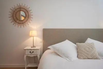 a bedroom with a bed and a mirror on the wall at Cannes Center, Nice 110m2, 3BR & 3BTH, Terrace in Cannes