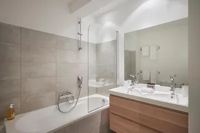 a bathroom with a tub and two sinks and a shower at Cannes Center, Nice 110m2, 3BR & 3BTH, Terrace in Cannes