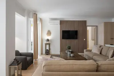 a living room with a couch and a tv at Cannes Center, Nice 110m2, 3BR & 3BTH, Terrace in Cannes