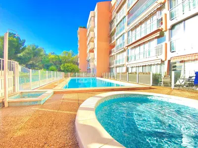 a swimming pool in front of a building at Vogue By SCLS Locations in Cannes