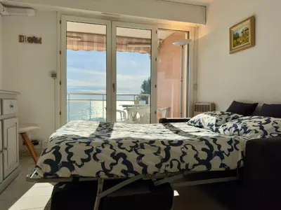 a bedroom with a bed and a view of the ocean at Vogue By SCLS Locations in Cannes