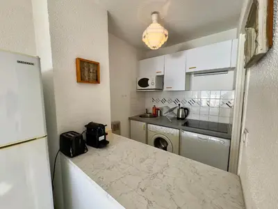 a kitchen with a marble counter top in a room at Vogue By SCLS Locations in Cannes