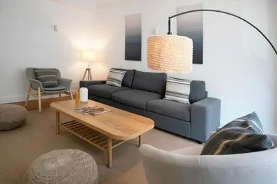 a living room with a couch and a table at Le Palais Madrid in Cannes