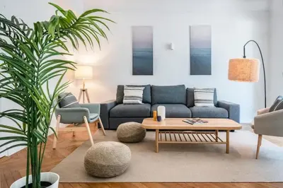 a living room with a blue couch and a table at Le Palais Madrid in Cannes