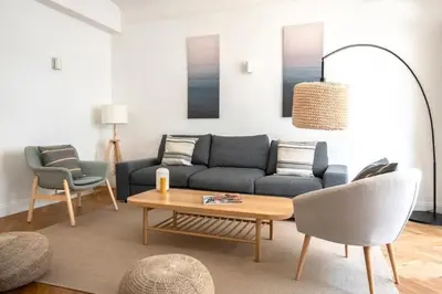 a living room with a couch and a table at Le Palais Madrid in Cannes