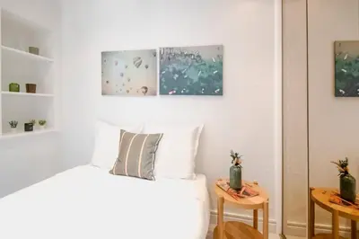 a bedroom with a bed and two side tables at Le Palais Madrid in Cannes