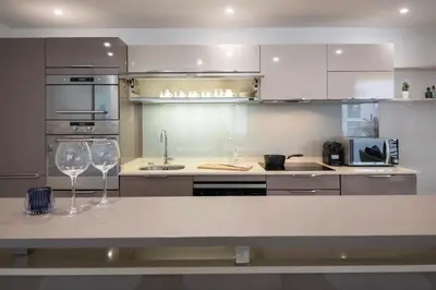 a kitchen with two wine glasses sitting on a counter at Le Palais Madrid in Cannes