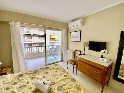 a bedroom with a bed and a desk and a television at Palais Royal Croisette GIA5407 in Cannes