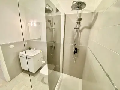 a bathroom with a shower with a toilet and a sink at Palais Royal Croisette GIA5407 in Cannes