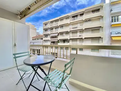 a table and chairs on a balcony with a building at Palais Royal Croisette GIA5407 in Cannes