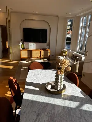 a living room with a table and a couch at Superbe appartement Art Déco avec roof top in Cannes