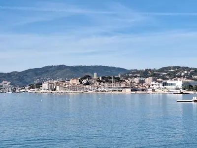 a large body of water with a city in the background at Superbe appartement Art Déco avec roof top in Cannes