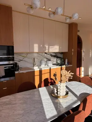 a kitchen with a table with chairs and a counter top at Superbe appartement Art Déco avec roof top in Cannes