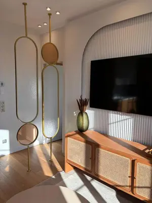a living room with a flat screen tv and a table at Superbe appartement Art Déco avec roof top in Cannes