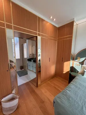 a bedroom with wooden cabinets and a bed in a room at Superbe appartement Art Déco avec roof top in Cannes