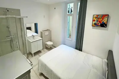 a bedroom with a bed and a bathroom with a sink at REF 1971- Apartment for rent basse Californie in Cannes