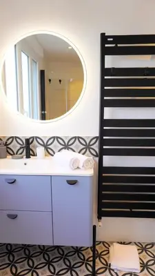 a bathroom with a white sink and a mirror at Proche Croisette, Appartement 2 Chambres by Palmazur Vacances in Cannes