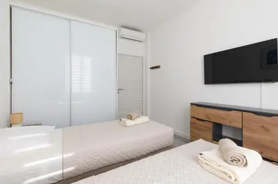 a bedroom with two beds and a flat screen tv at Modern Jaurès-Center-Clim-Wifi-Festival in Cannes