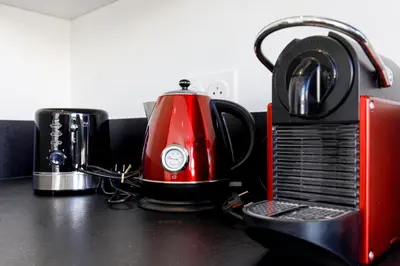 a red tea kettle sitting on top of a counter at Modern Jaurès-Center-Clim-Wifi-Festival in Cannes