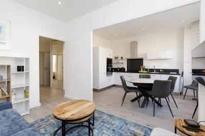 a living room and kitchen with a table and chairs at Modern Jaurès-Center-Clim-Wifi-Festival in Cannes