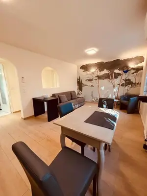 a living room with a table and a couch at Agréable 2 pièces avec terrasse et jardin in Cannes