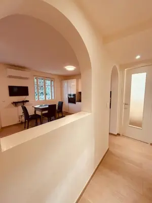 a living room with a table and a dining room at Agréable 2 pièces avec terrasse et jardin in Cannes