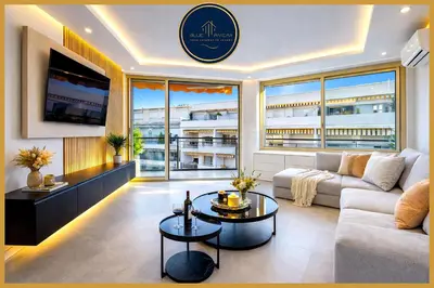 a living room with a couch and a table at Prestige Maubourg & Exclusive Sea View Terrace in Cannes