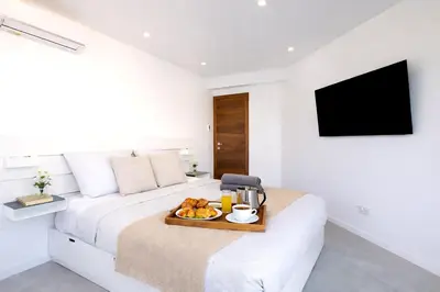 a bedroom with a bed with a tray of food on it at Prestige Maubourg & Exclusive Sea View Terrace in Cannes