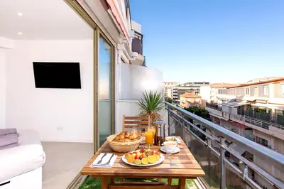a balcony with a table with fruit on it at Prestige Maubourg & Exclusive Sea View Terrace in Cannes
