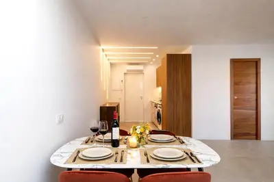 a dining room table with two plates and wine glasses at Prestige Maubourg & Exclusive Sea View Terrace in Cannes