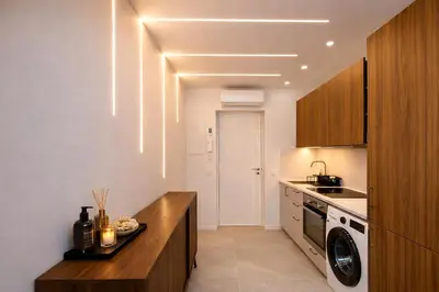a kitchen with a washer and dryer in it at Prestige Maubourg & Exclusive Sea View Terrace in Cannes