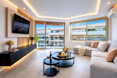 a living room with a couch and a table at Prestige Maubourg & Exclusive Sea View Terrace in Cannes