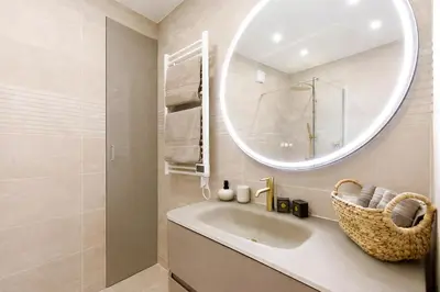a bathroom with a sink and a mirror at Prestige Maubourg & Exclusive Sea View Terrace in Cannes